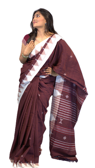 Elegant Kotpad saree handwoven in Odisha with natural Aul tree dyes, tribal motifs, and matching blouse piece