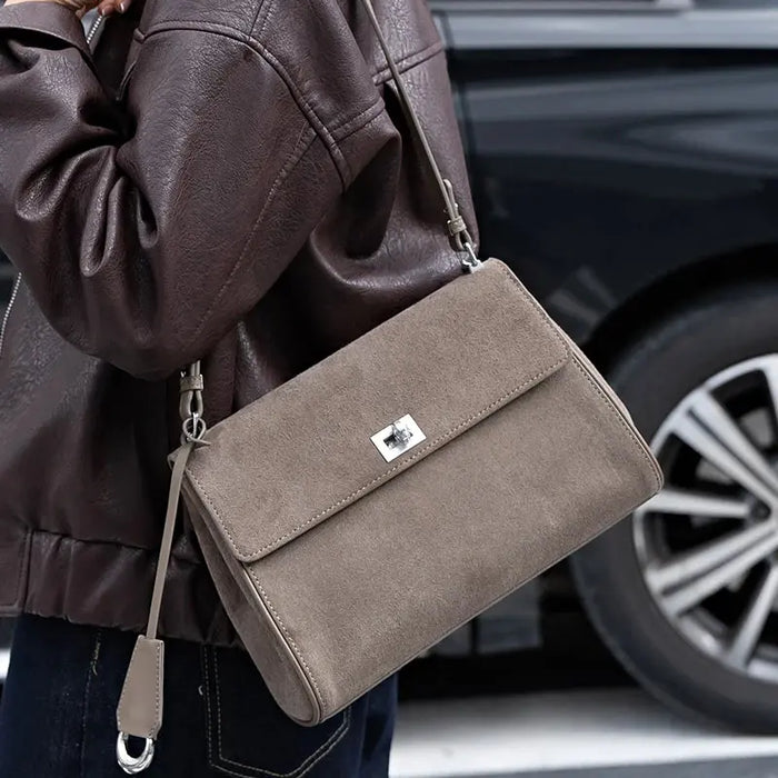 Women’s minimalist leather shoulder bag with hasp closure and casual tote design