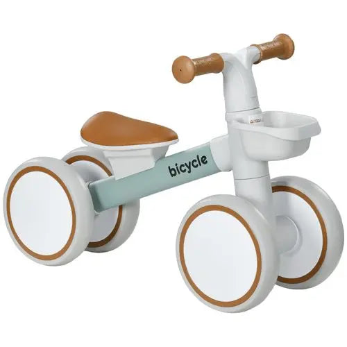 British toddler riding a lightweight balance bike with no pedals, adjustable seat and foam wheels on a garden path, family-friendly design