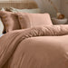duvet cover set in pastel tones with wooden button closure, showcasing modern crinkle texture and breathable fabric.