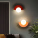Art Deco black and gold wall sconce with plastic ball design mounted on wall