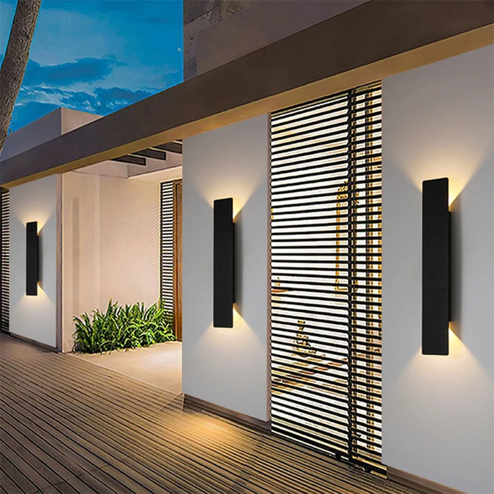 IP65-rated black aluminum outdoor wall lamp illuminating a modern garden patio Waterproof outdoor LED wall lamp for garden, patio, or exterior home lighting 