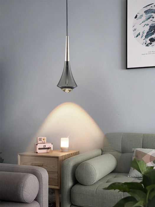 Modern aluminum pendant light hanging over a stylish dining space