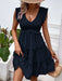 Chic ruffled blouse with smocked detailing, ruched accents, and a flattering fit.