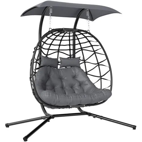Double rattan swing chair with canopy, cushions, and steel frame for outdoor garden or patio use

