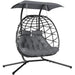 Double rattan swing chair with canopy, cushions, and steel frame for outdoor garden or patio use

