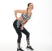 Model wearing Aso-Oke pastel print leggings with a high-compression waistband